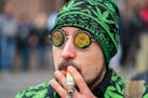 Andrew “Reeferman” Sumner smokes a cannagar during Hash Bash on the University of Michigan campus in Ann Arbor, Mich., on April 1, 2023.