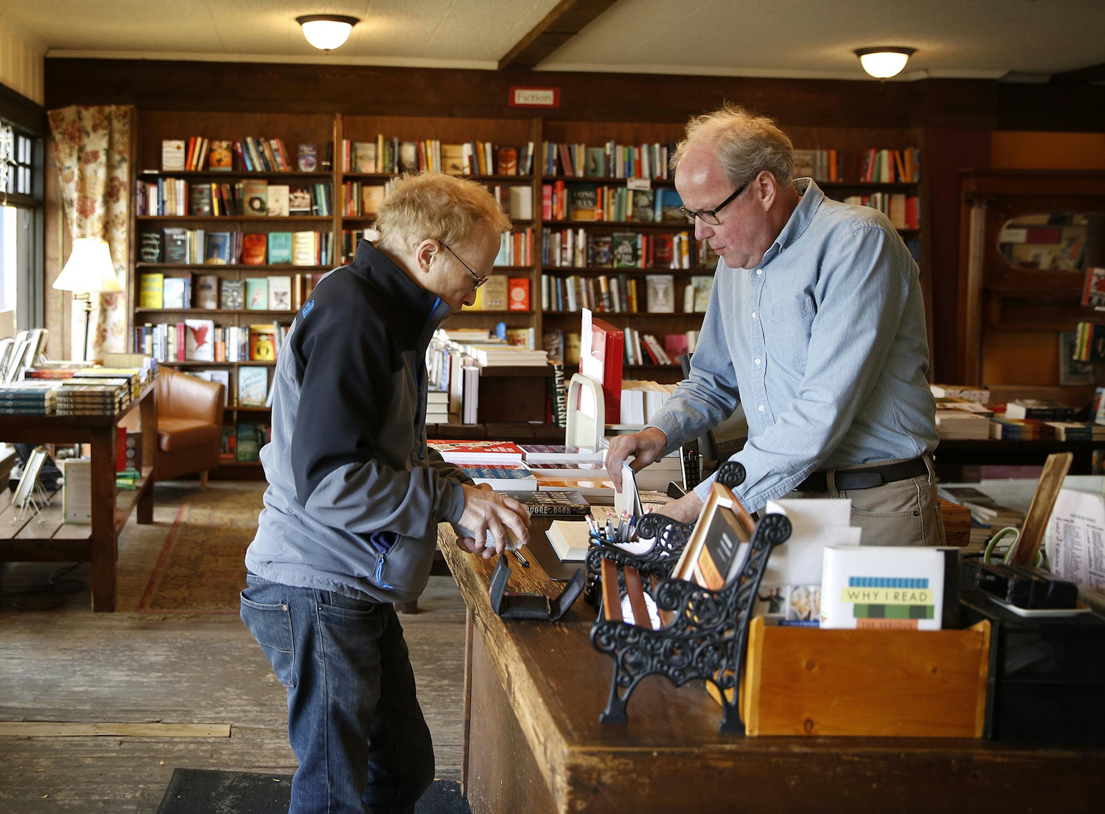 Tom Bielenberg, right, owner of Micawbers Books in St. Paul, sells a book to William "Skip" Dykoski of New Brighton. ] LEILA NAVIDI leila.navidi@startribune.com / BACKGROUND INFORMATION: Wednesday, October 22, 2014. Micawbers is a longtime independent neighborhood bookseller, trying to survive in the age of online competition and big box retailers.