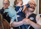 Campaign manager Daniel Cox held his 1-year-old daughter Tlameha at the Rondo Library on Sunday in St. Paul. Cox and his partner have experienced chil