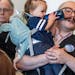 Campaign manager Daniel Cox held his 1-year-old daughter Tlameha at the Rondo Library on Sunday in St. Paul. Cox and his partner have experienced chil