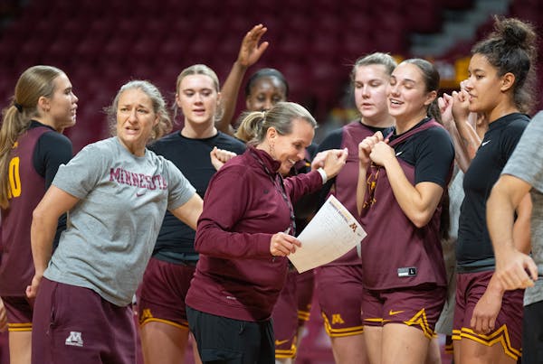 Gophers women’s basketball coach Dawn Plitzuweit, middle, will be making her Williams Arena head coaching debut Wednesday night.