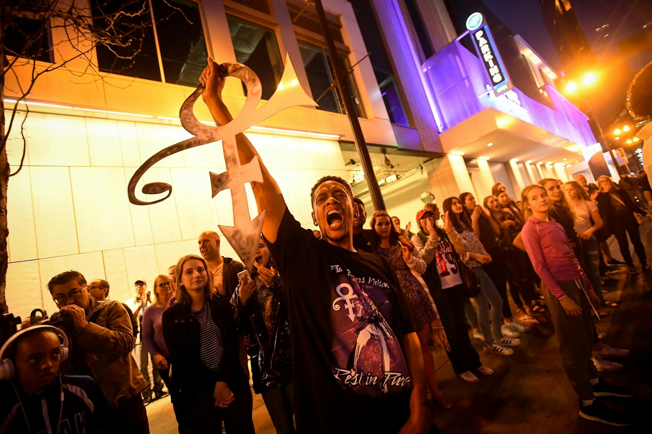 Tye Lopez, of Wichita, sang along with Prince's music while taking part in an impromptu dance party outside of First Ave's Prince memorial block party.