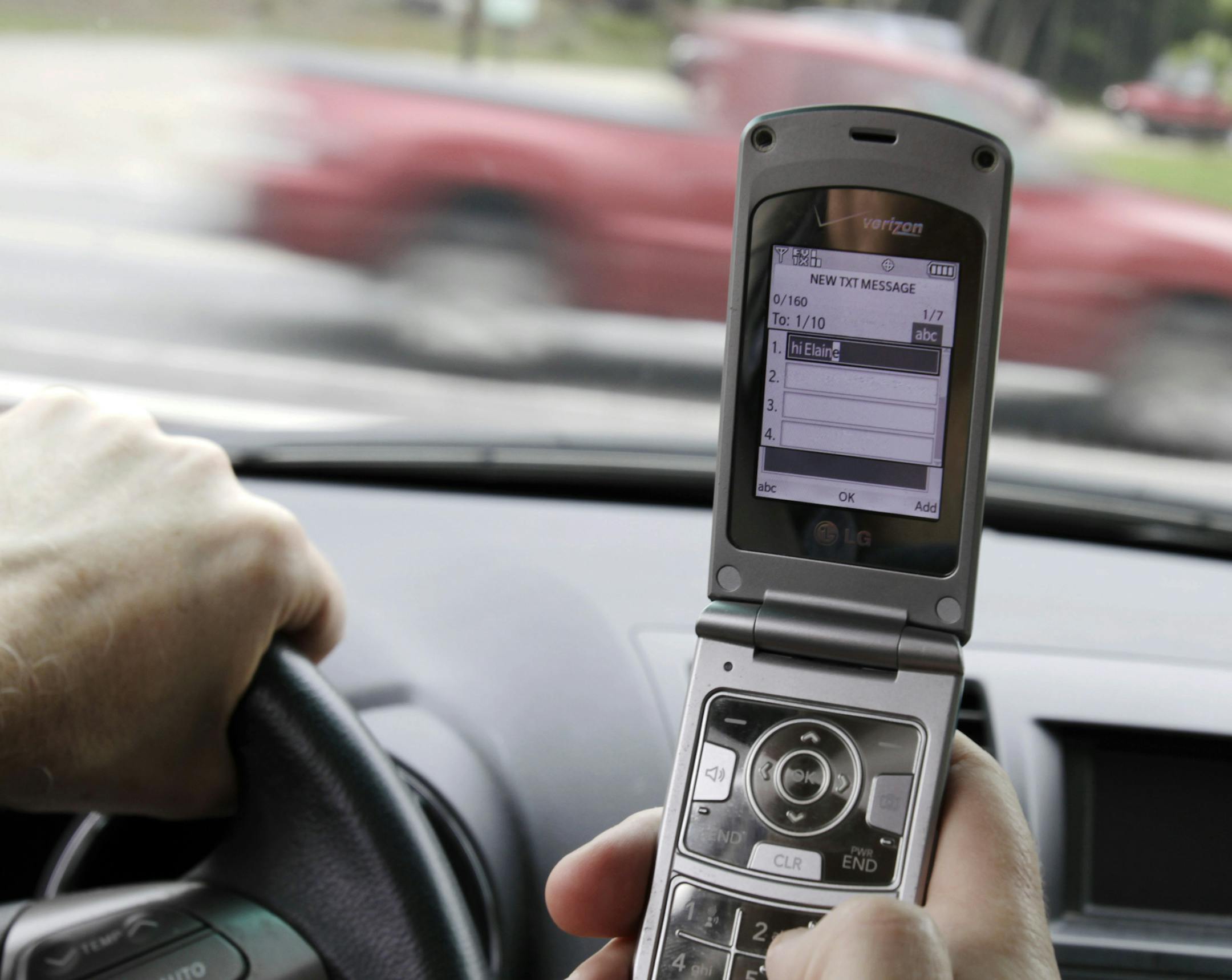 In this Sept. 20, 2011 photo, Joseph Dea, of West Hollywood, Calif., pauses as he texts while driving in a car in Brunswick, Maine, in this posed photo. The texting ban is prominent among the scores of laws taking effect Wednesday, Sept. 28, the 90th day after the close of the 2011 regular session. (AP Photo/Pat Wellenbach) ORG XMIT: MIN2015052220494857