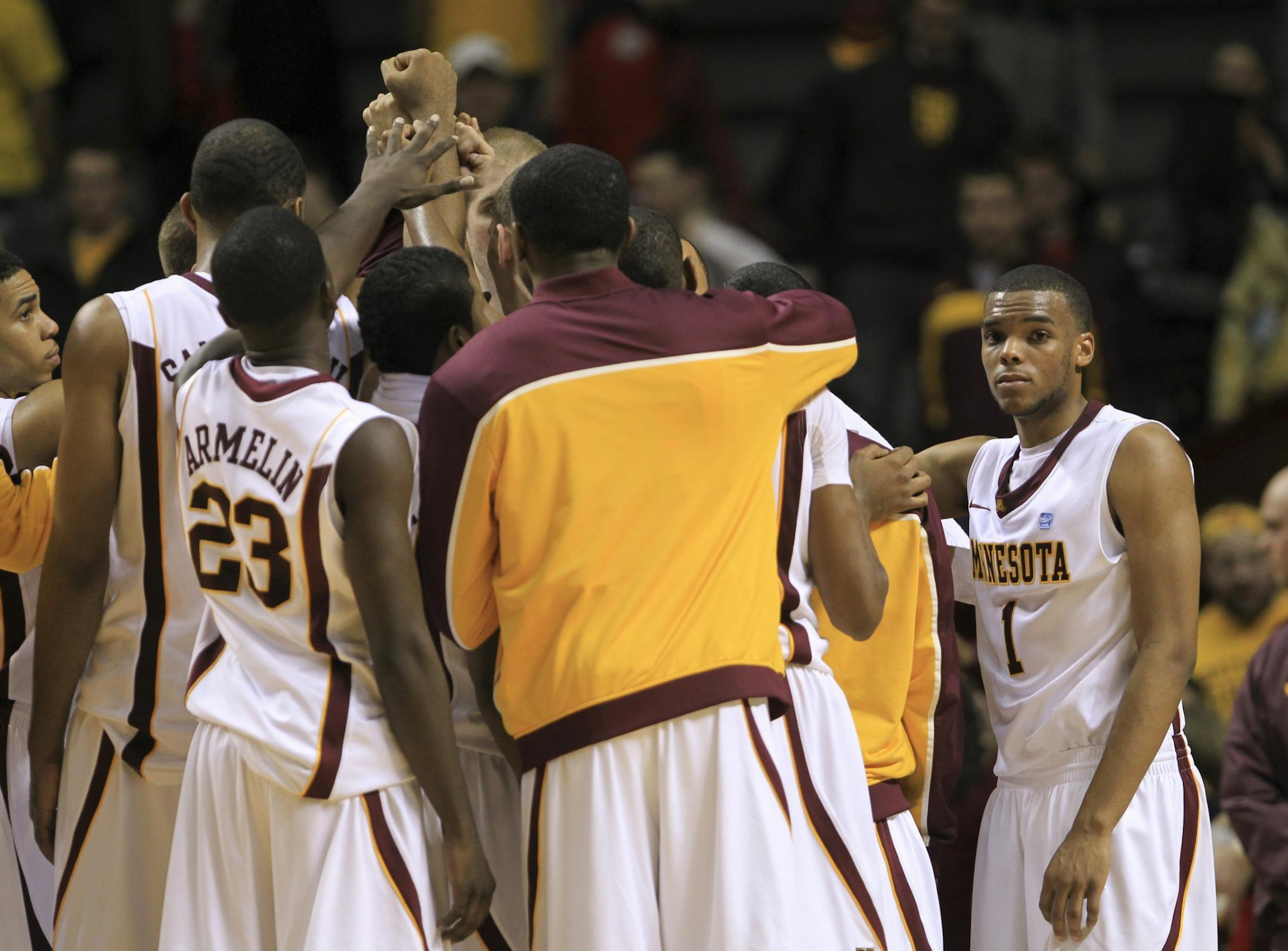 The Gophers' leading scorer, Andre Hollins, looked glum in the post-game huddle after an overtime loss to Wisconsin. The University of Minnesota men's basketball team lost in overtime 68-61 to the University of Wisconsin Badgers Thursday night, February 9, 2012 at Williams Arena in Minneapolis, Minn.