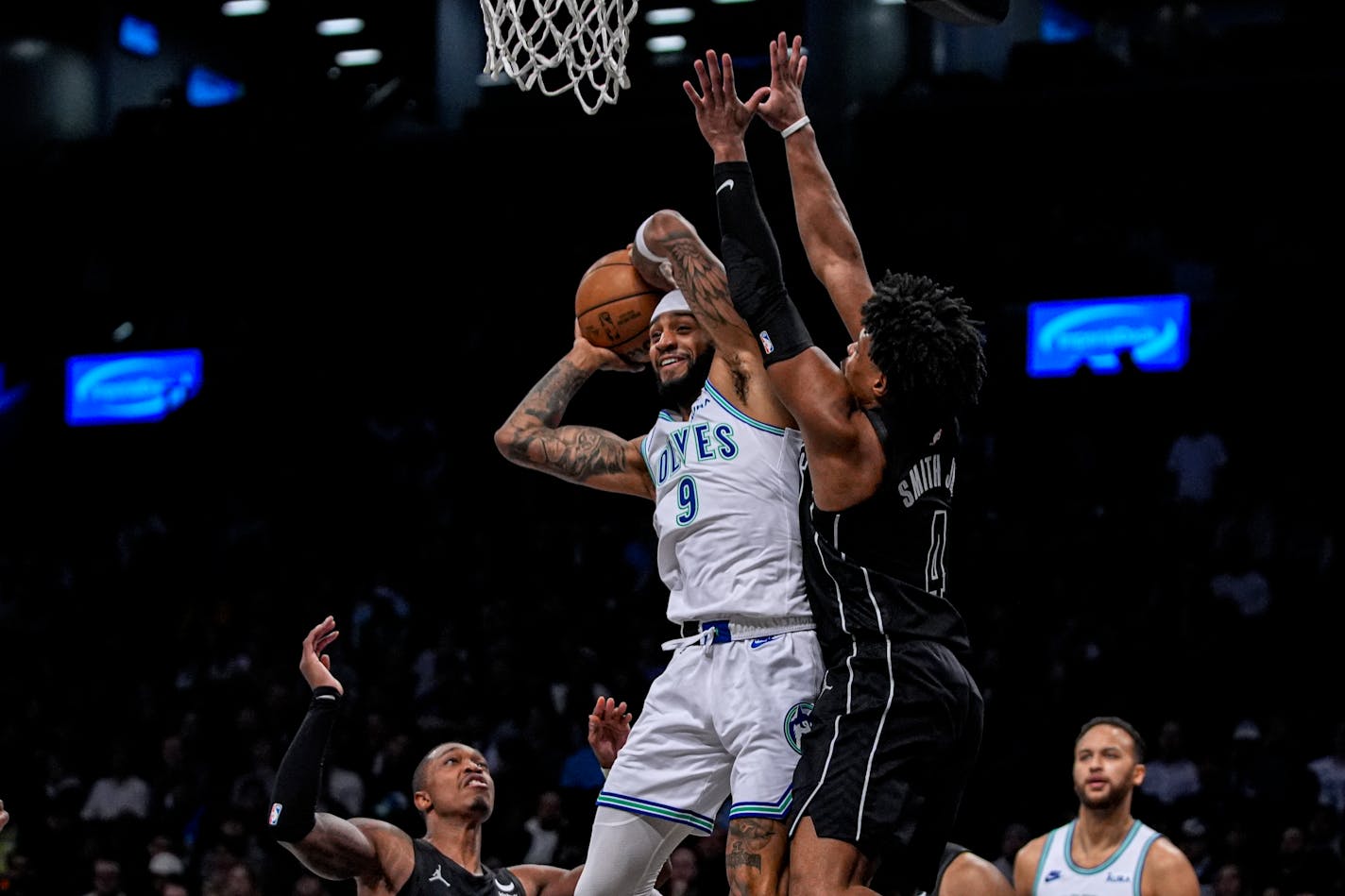 Nickeil Alexander-Walker looks to pass the ball while defended by Brooklyn Nets guard Dennis Smith Jr. on Thursday.