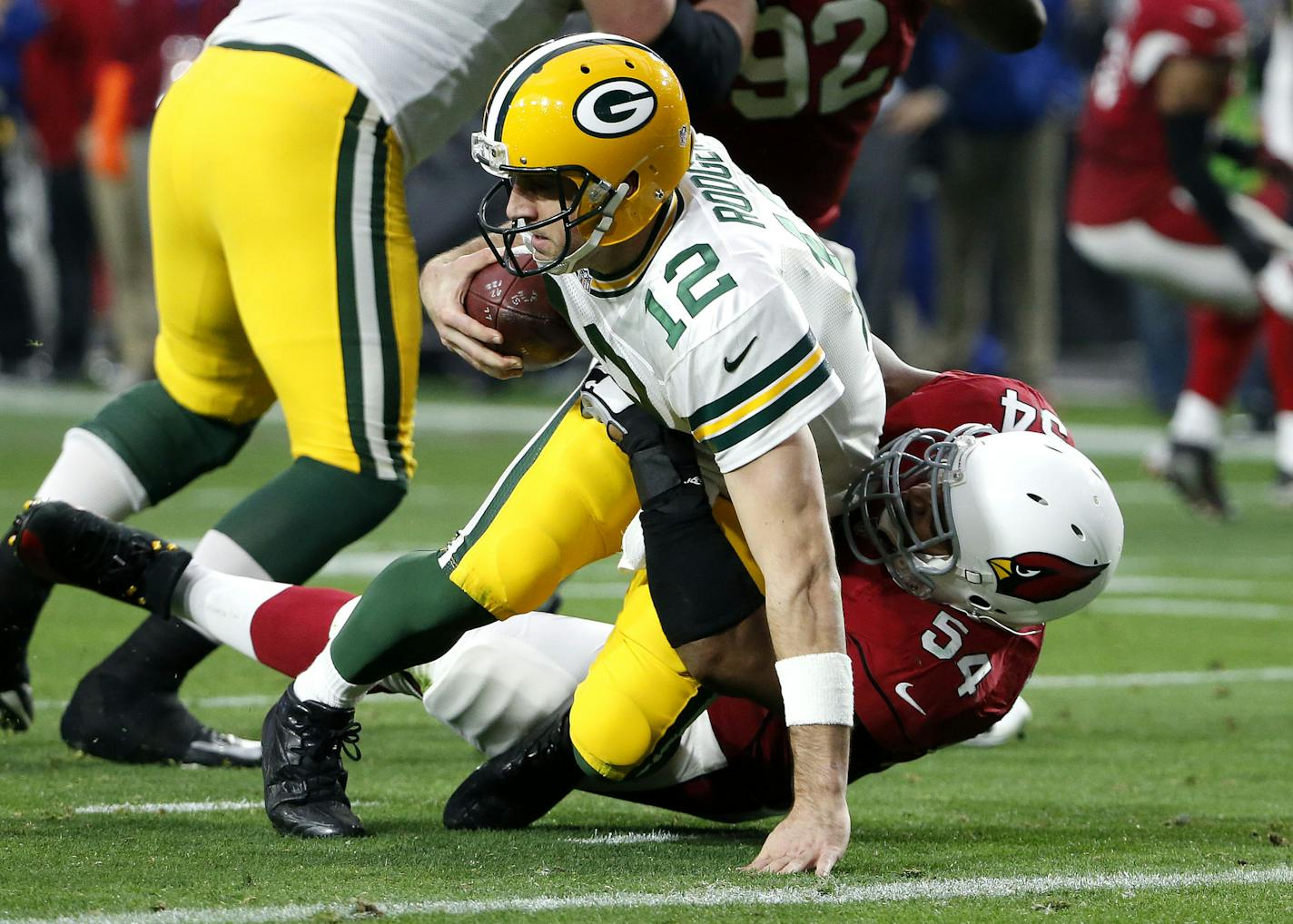 Green Bay Packers quarterback Aaron Rodgers (12) is sacked by Arizona Cardinals inside linebacker Dwight Freeney during the second half of an NFL football game, Sunday, Dec. 27, 2015, in Glendale, Ariz. (AP Photo/Ross D. Franklin) ORG XMIT: AZMY