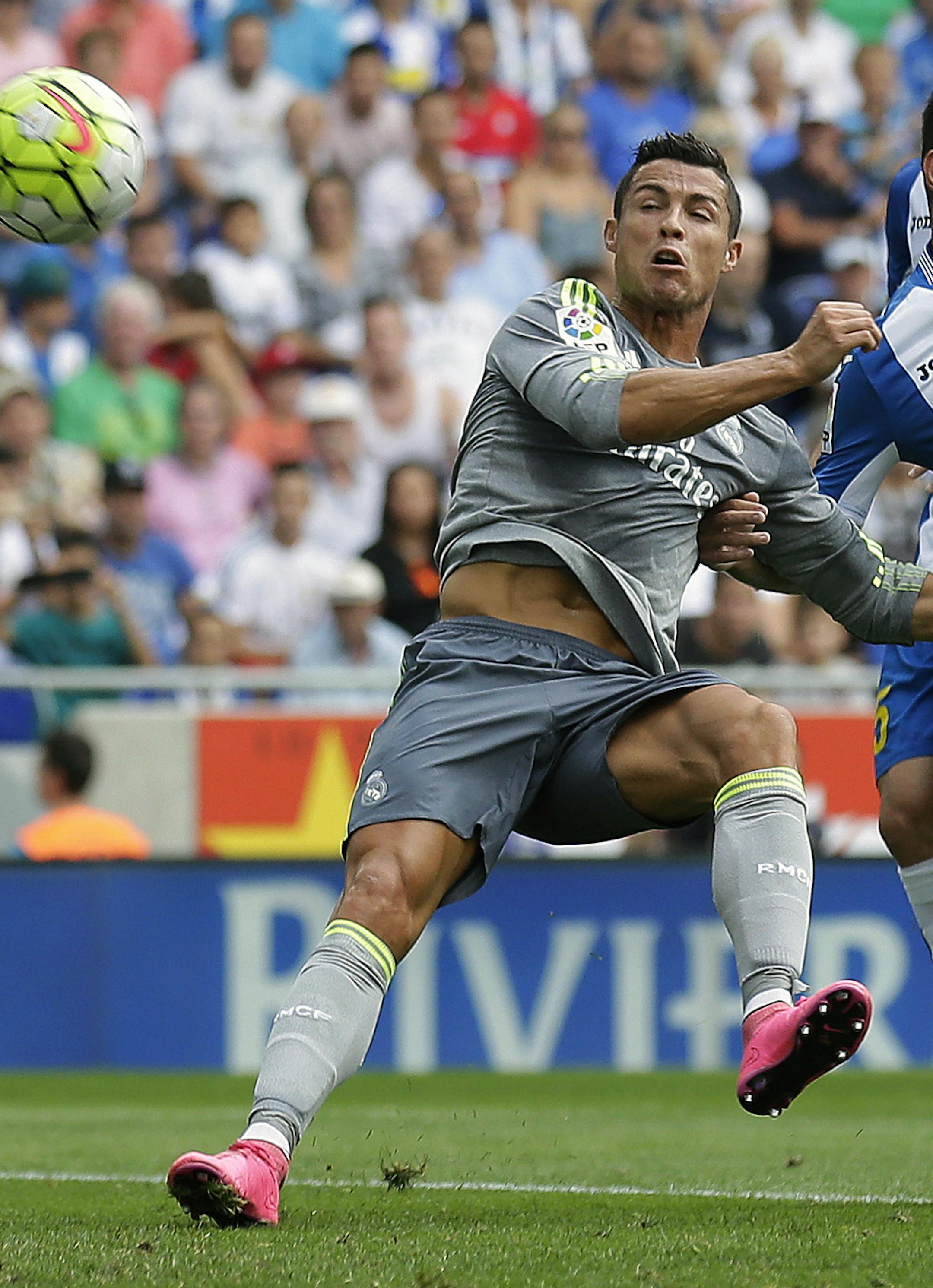 Real Madrid's Cristiano Ronaldo, center, shoots towards Espanyol goalkeeper Pau Lopez during a Spanish La Liga soccer match at Cornella-El Prat stadium in Cornella Llobregat, Spain, Saturday, Sept. 12, 2015. (AP Photo/Manu Fernandez) ORG XMIT: MF116