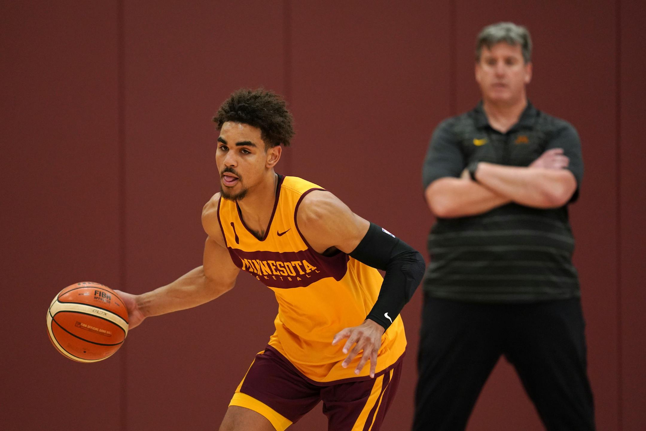 Gophers guard Tre' Williams drove to the basket as assistant coach Ed Conroy watched during a team practice before leaving for Italy.