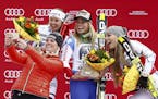 Retired Austrian World Cup skier Nicole Hosp, foreground, takes a selfie with Switzerland's Lara Gut, center, winner of an Alpine ski women's World Cu