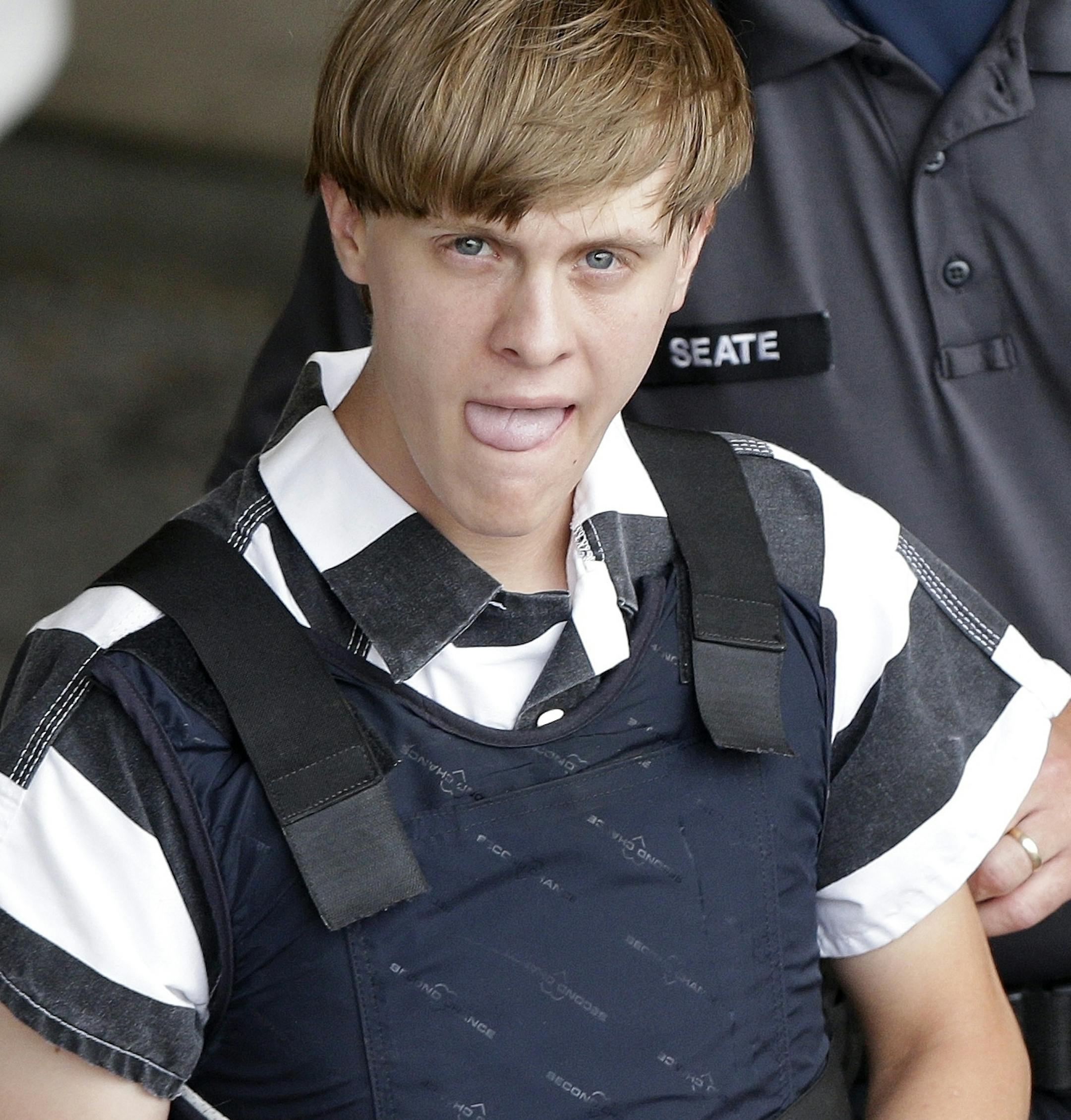 FILE -In this Thursday, June 18, 2015 file photo, convicted shooter Dylann Roof is escorted from the Cleveland County Courthouse in Shelby, N.C. Roof was convicted of killing nine congregants at Emanuel AME Church, Wednesday, June 17, 2015 in Charleston, S.C. A federal jury will consider whether Roof should be sentenced to death or life in prison for killing nine black church members in the racially motivated attack. (AP Photo/Chuck Burton, File)