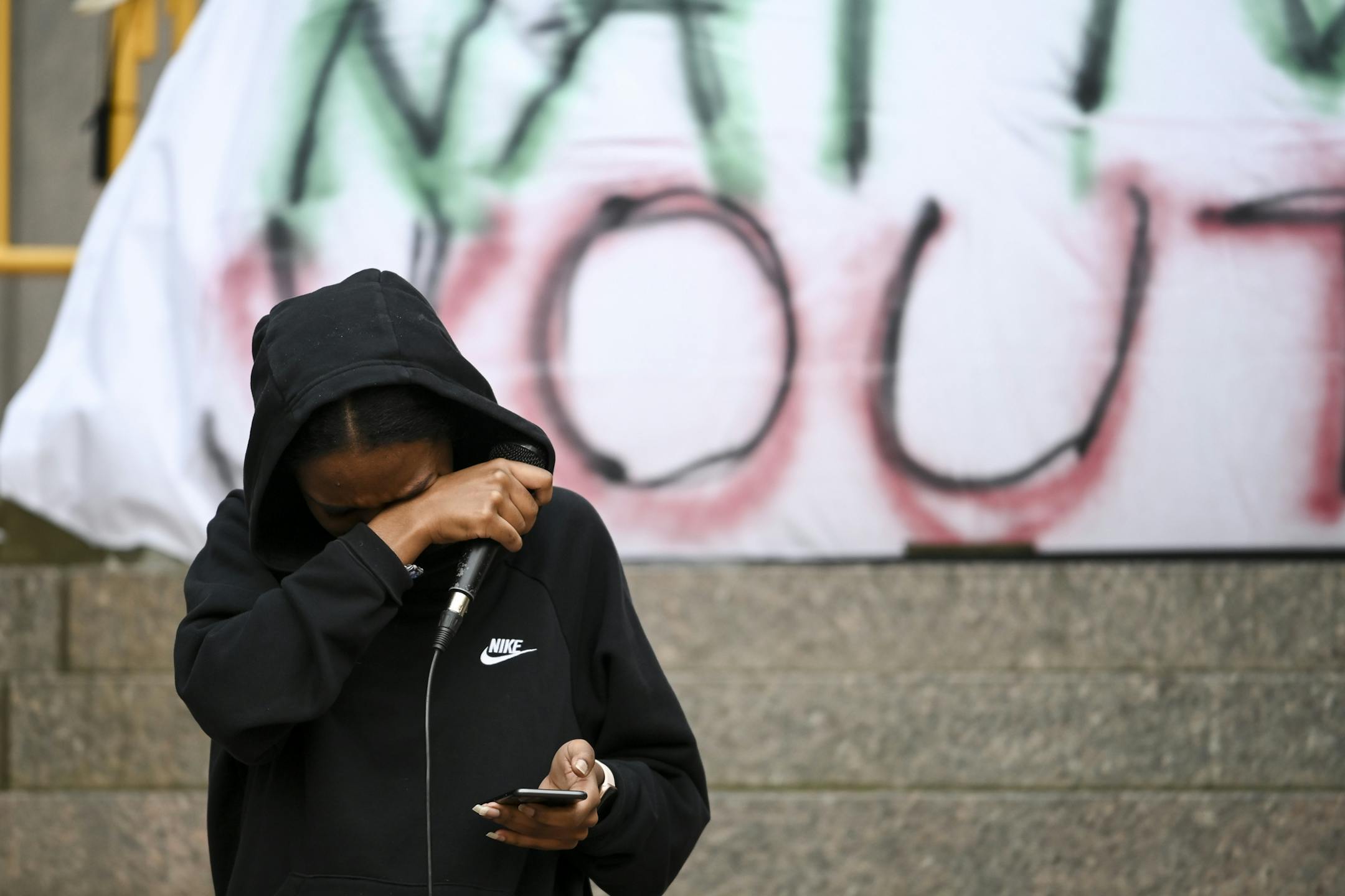 Hayat Kabeto, of St. Paul, was overcome with emotion as she read spoken word poetry about police brutality at Saturday's rally.