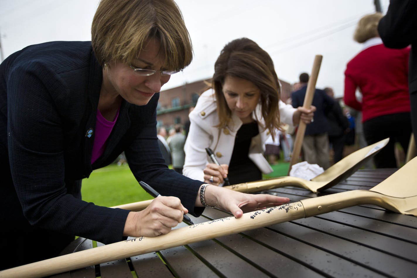 Sen. Amy Klobuchar and Rep. Michele Bachmann signed shovels at a ground breaking ceremony for the new St. Croix River Bridge on Tuesday, May 28, 2013 in Stillwater, Minn. ] (RENEE JONES SCHNEIDER * reneejones@startribune.com)