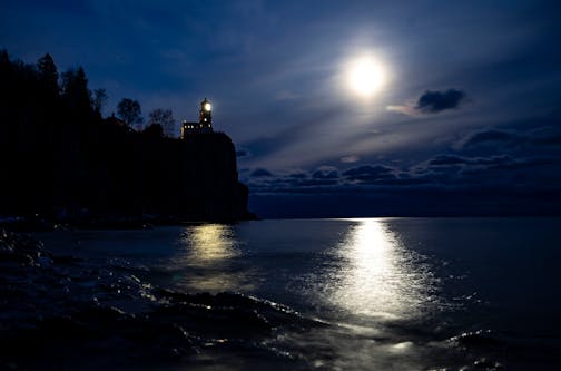 A bright moon shines over Lake Superior near Split Rock Lighthouse in Lake County, north of Two Harbors, Minn.