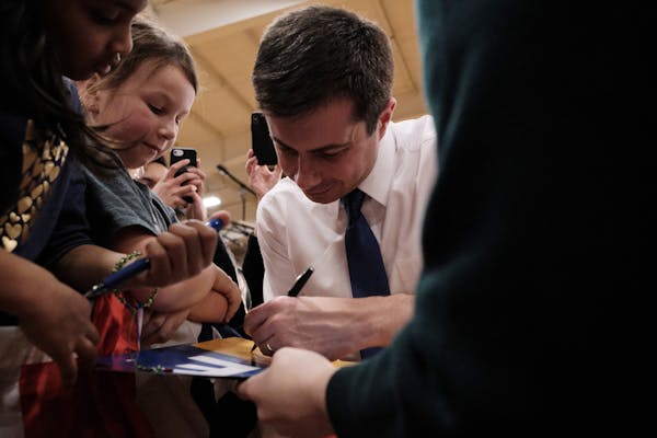 Pete Buttigieg, the former mayor of South Bend, Ind., a Democratic candidate for president, signs autographs during a town hall campaign event at Spar