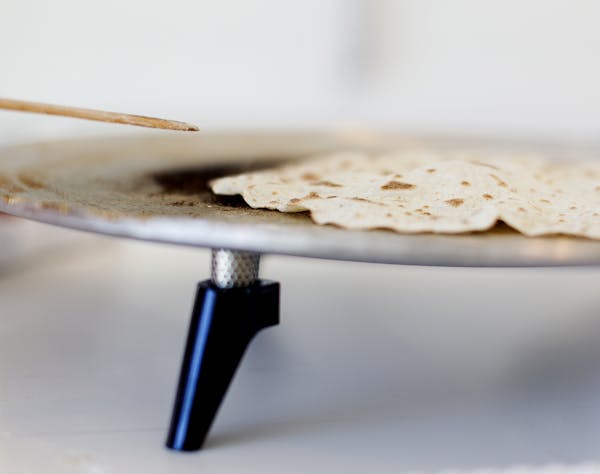One sign of a perfectly-cooking lefse is the slight protrusion of an air pocket. The women of the Circle of Gratitude group from Minneapolis' Central 