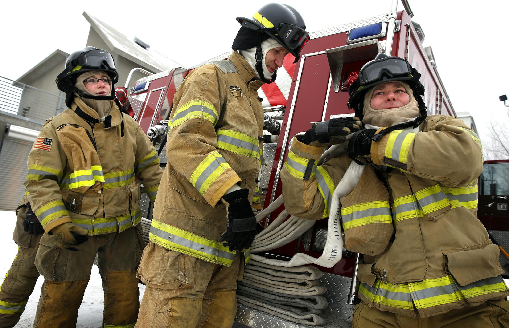 Lino Lakes Police Sergeant Mike Rumpsa, from right, Captain Wayne Wegener and Officer Jackie McIntosh participate in the Fire Fighter I class at the Century College firefighter training facility in Oakdale on Wednesday, December 10, 2014. ] LEILA NAVIDI leila.navidi@startribune.com / BACKGROUND INFORMATION: The city of Lino Lakes has dropped out of the tri-city Centennial Lakes Fire Department and will have it's 26 Lino Lakes Police officers serve as the city's firefighters as well.