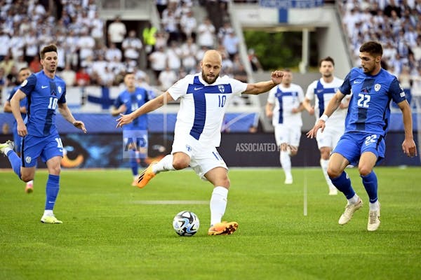 Teemu Pukki of Finland shoots wide while Adam Gnezda Cerin (R) of Slovenia observes during UEFA Euro 2024 football tournament qualifying match Finland