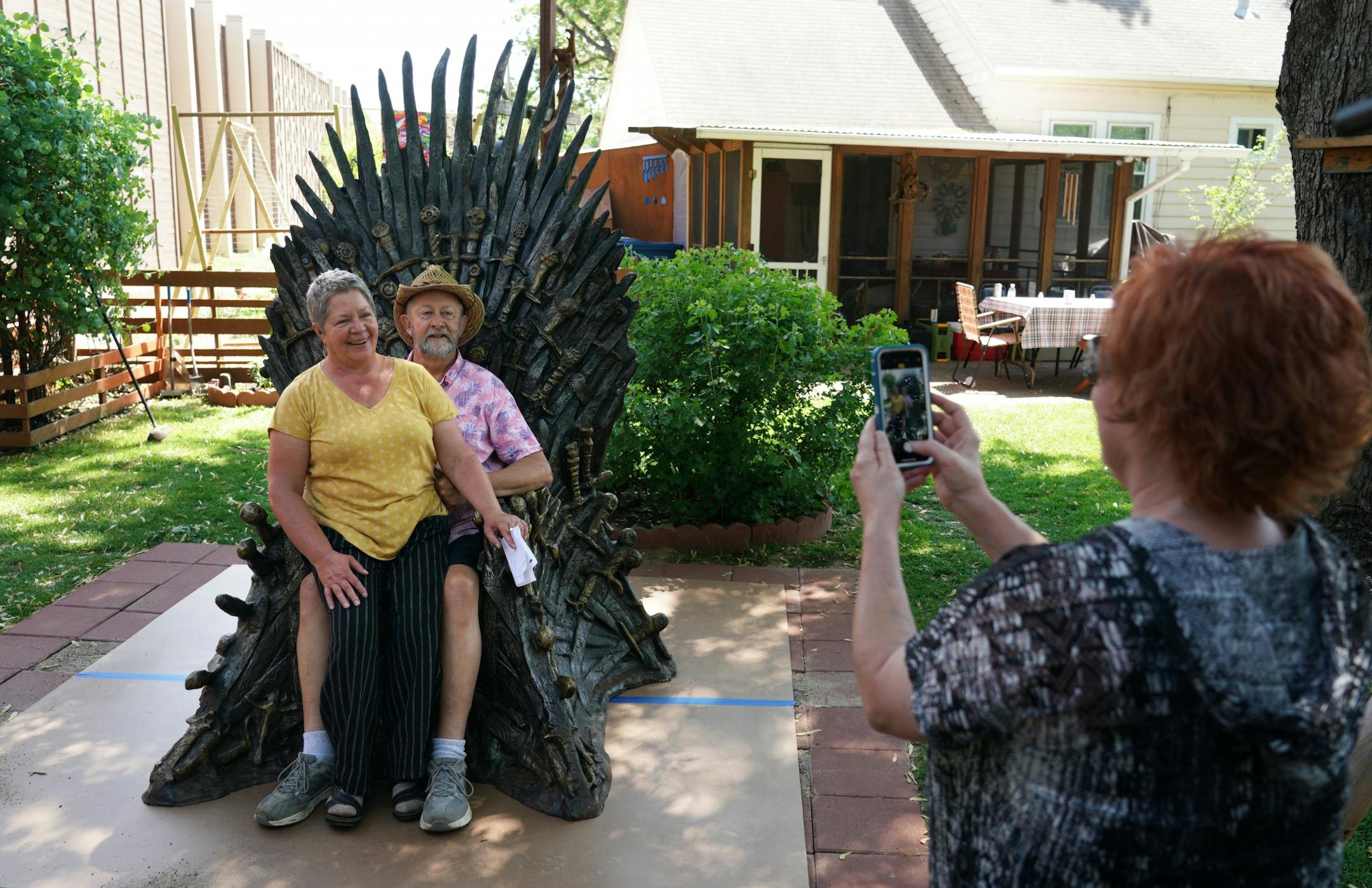 Ken and Gail James, a retired couple who live in Richfield, entered a national contest and won their own life-sized replica version of the Iron Throne from the HBO show, Game of Thrones. Here, Gail and Ken James get their picture taken on their new Iron Throne in their backyard.