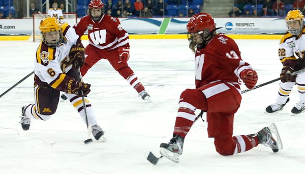 Kate Schipper shot the puck by Wisconsin's Katarina Zgraja during the second period of the national semifinals Friday night.