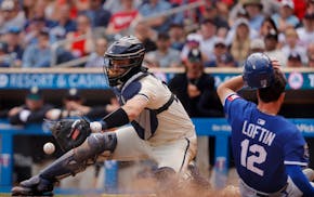 The Royals' Nick Loftin scores as Twins catcher Ryan Jeffers waits for the throw on a single by Maikel Garcia in the 10th inning Sunday.