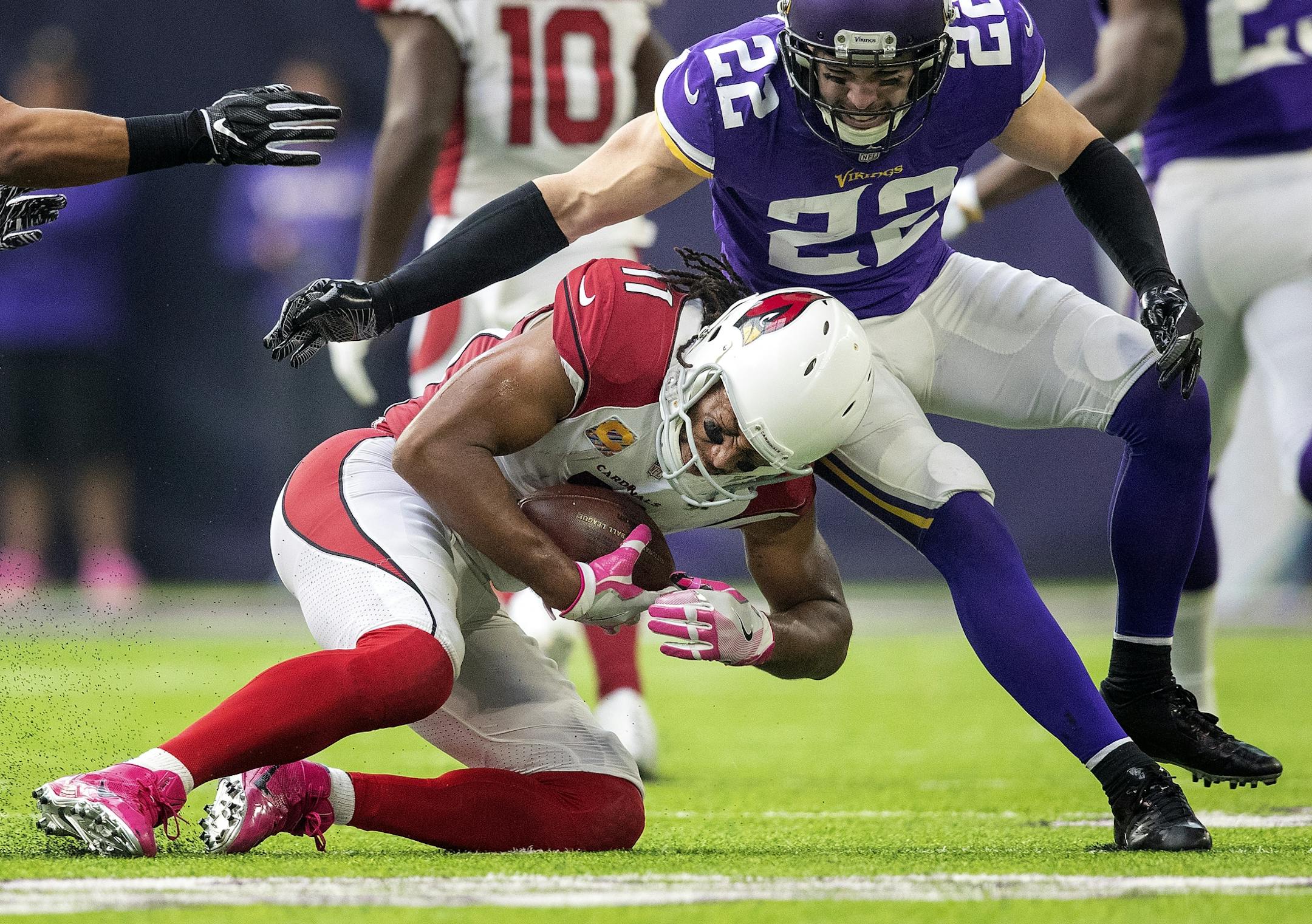 Larry Fitzgerald was tackled by Harrison Smith (22) in the fourth quarter.