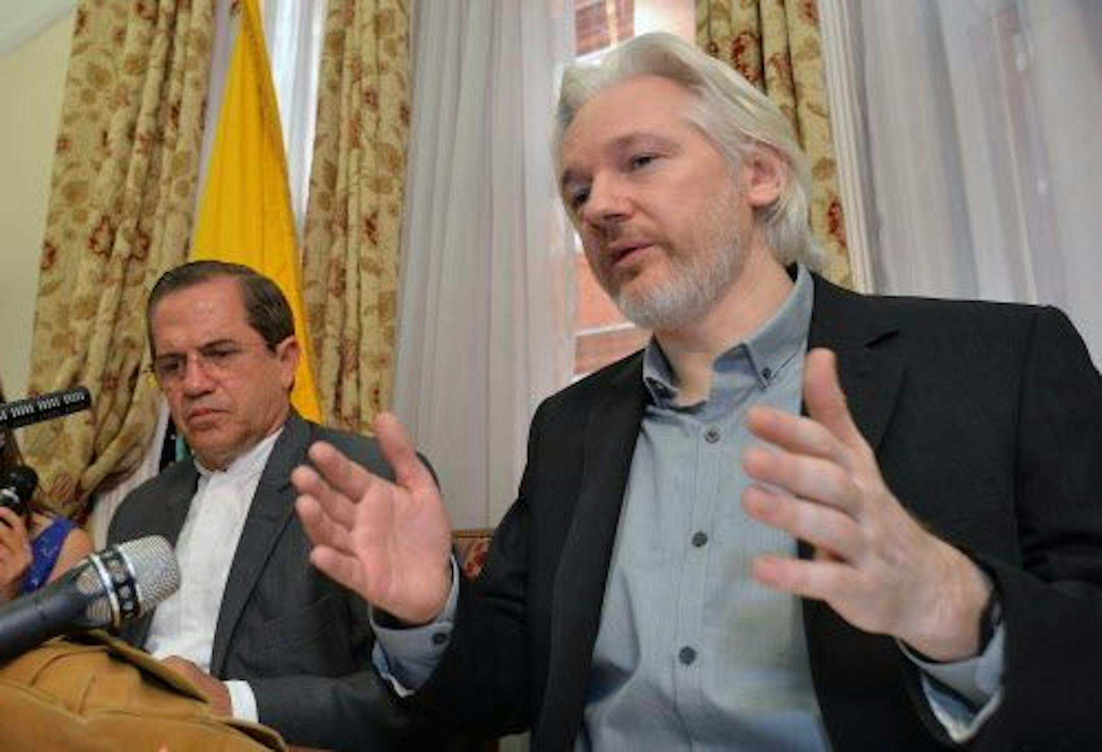 Ecuador's Foreign Minister Ricardo Patino, left, and WikiLeaks founder Julian Assange speak during a press conference inside the Ecuadorian Embassy in London on Monday Aug. 18, 2014.