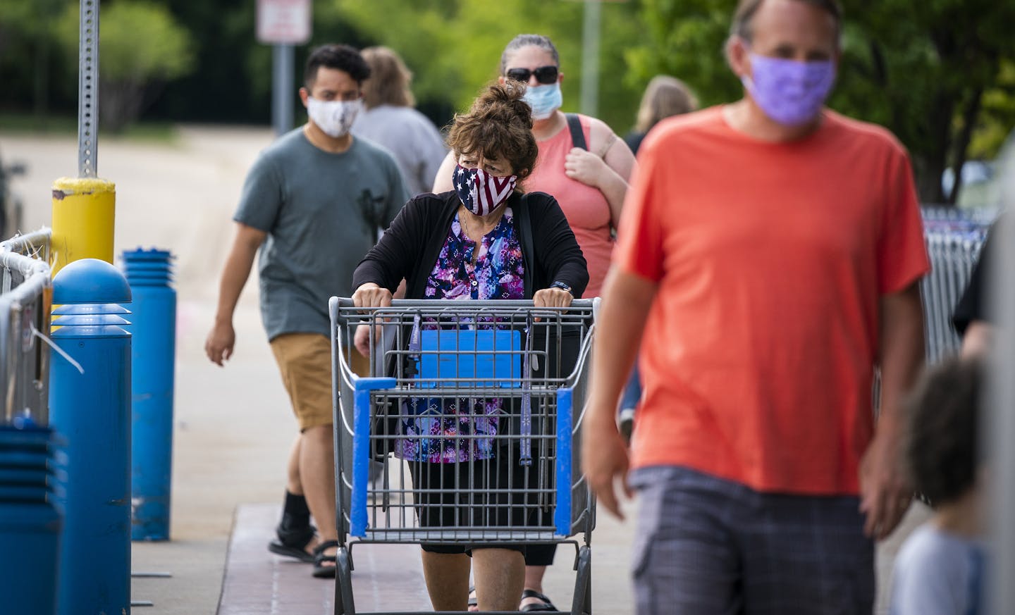 Shoppers entered the Walmart in Apple Valley on Friday. Minnesota health officials are urging people to wear masks to slow the spread of COVID-19.