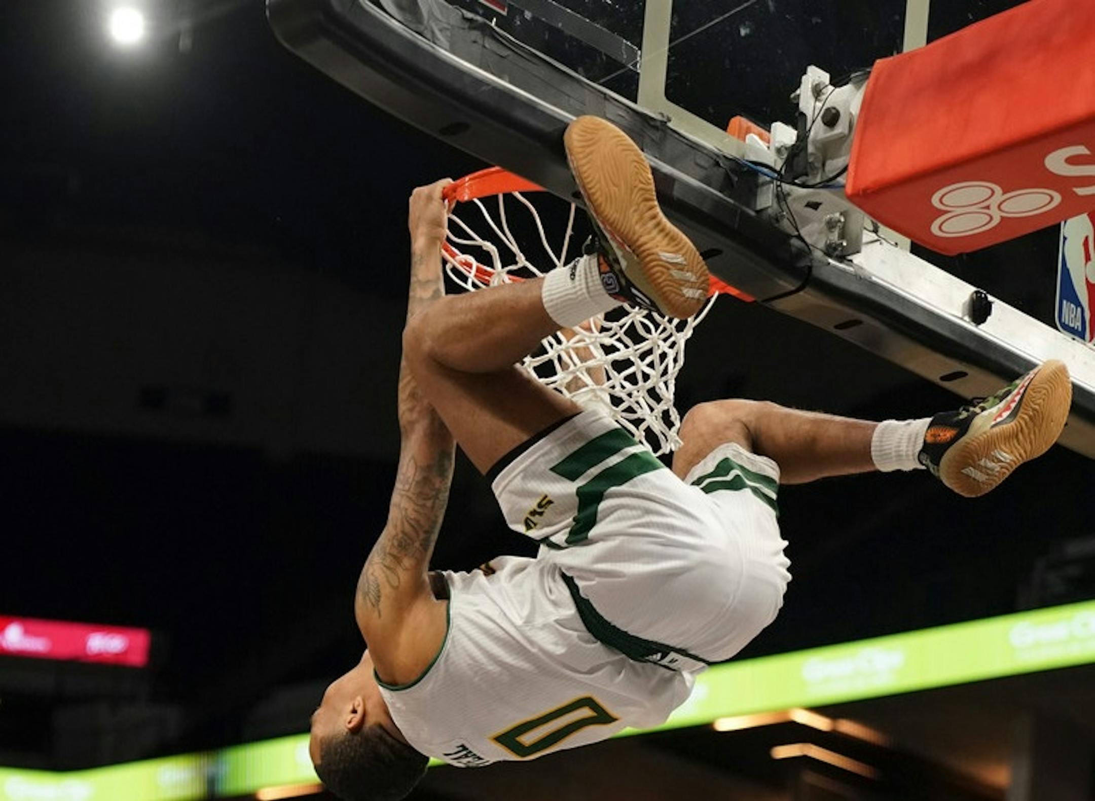 SE Louisiana State's Marlain Veal hugged the rim after dunking Thursday night.