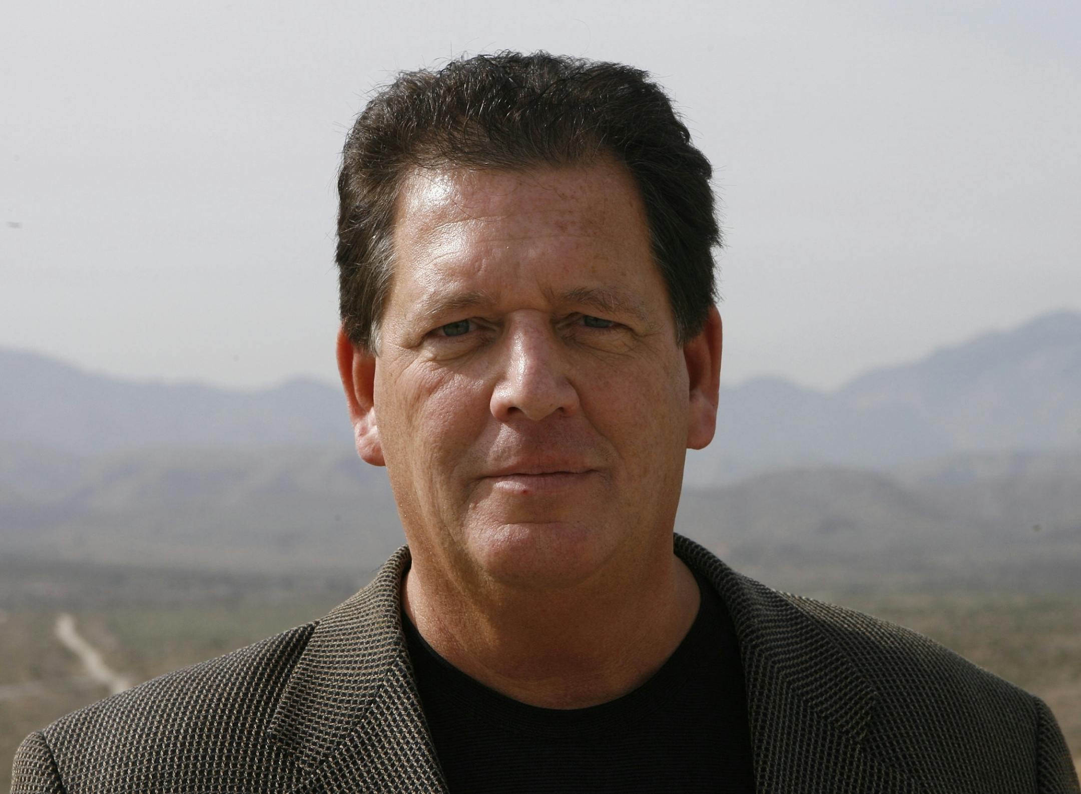 Michael Crosby, chief managing partner of Palmwood Golf Club, is shown in a 2006 file photo. Behind him are his 1,766 acres outside of Desert Hot Springs.