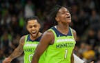 Minnesota Timberwolves guard Anthony Edwards (1) and guard D'Angelo Russell react after Edwards made a three point shot during the first half of an NB