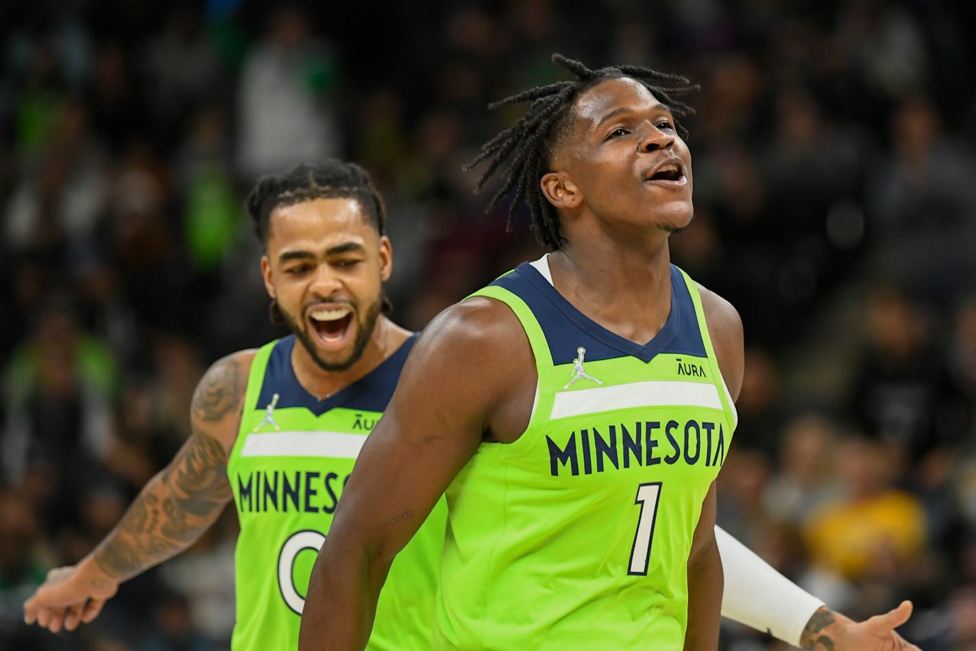 Minnesota Timberwolves guard Anthony Edwards (1) and guard D'Angelo Russell react after Edwards made a three point shot during the first half of an NBA basketball game Saturday, Nov. 20, 2021, in Minneapolis. (AP Photo/Craig Lassig)