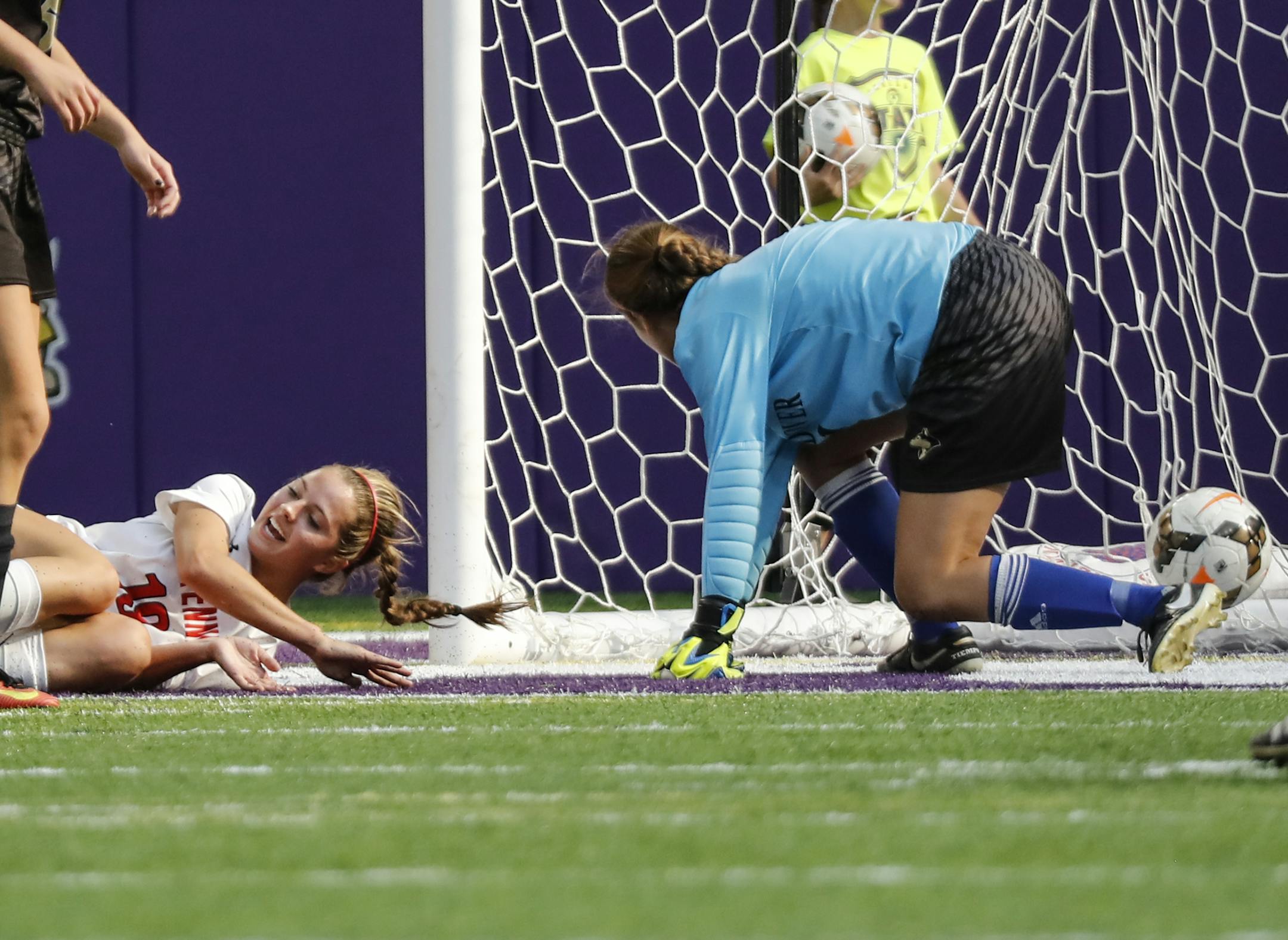 The winning shot by Centennial's Ashley Ebeling, left, made it past Andover goalie Aly Cole (1) during the second half of the girls AA semifinals. ] RENEE JONES SCHNEIDER • renee.jones@startribune.com Class 2A girls' soccer state semifinals on Tuesday, November 1, 2016, at U.S. Bank Stadium in Minneapolis, Minn. Andover vs. Centennial. Centennial won 2-1