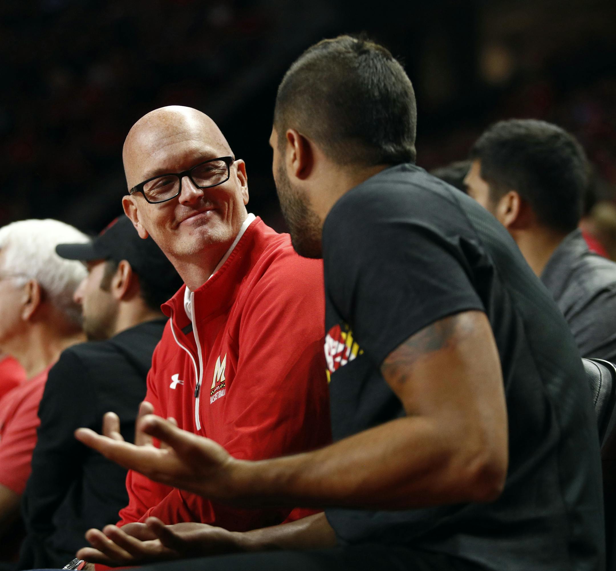 ESPN sportscaster Scott Van Pelt, left, speaks with former Maryland point guard Greivis Vasquez as they sit courtside in the first half of an NCAA college basketball game between Maryland and Michigan State in College Park, Md., Sunday, Jan. 28, 2018. (AP Photo/Patrick Semansky) ORG XMIT: OTK