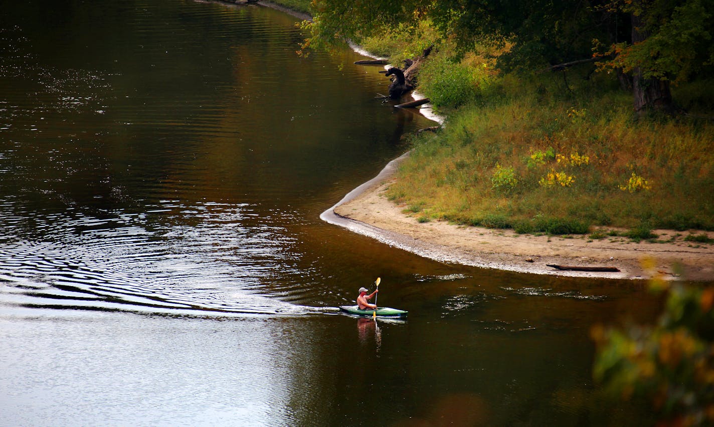 BRIAN PETERSON ¥ brianp@startribune.com St. Paul, MN 9/24/2009 ] A lone kayaker makes his way from the Minnesota River into the Mississippi near Pike Island near Fort Snelling Thursday afternoon. Minnesota and 11 other states in the watershed of the Mississippi River will get $320 million from the federal government to clean up the river. U.S. Agriculture Secretary Tom Vilsack announced the program today, calling the 2,350-mile river "a critical national resource." The Mississippi River Basin Healthy Watersheds Initiative is designed to improve water quality during the next four years in an attempt to shrink the "dead zone" the river's pollutants create in the Gulf of Mexico.