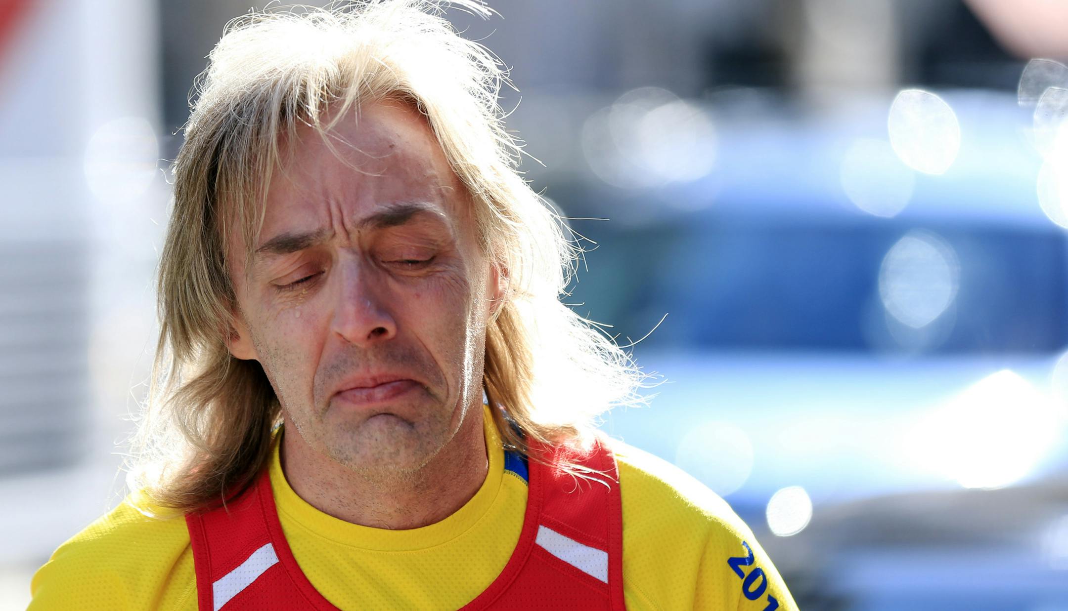 Tears collect on Ron McCracken's of Dallas cheek as he pays his respects at a makeshift memorial honoring to the victims of the 2013 Boston Marathon bombings ahead of Monday's 118th Boston Marathon, Sunday, April 20, 2014, in Boston. McCracken's race last year was cut short due to bombings and Monday's race will mark his 14th year running in the Boston Marathon. (AP Photo/Matt Rourke)