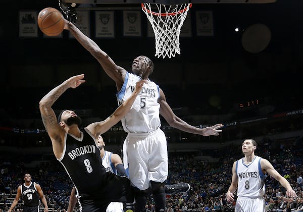 Gorgui Dieng (5) blocked a shot by Deron Williams (8) in the first quarter.