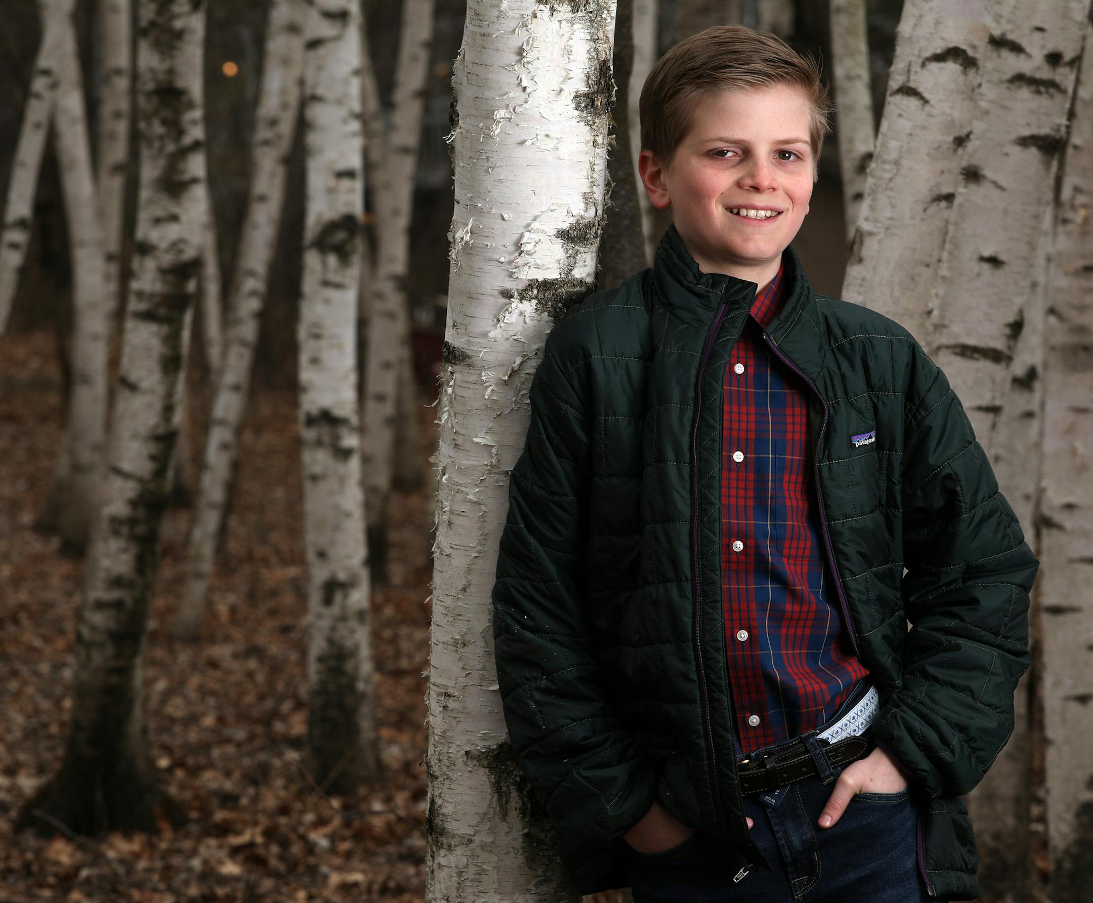 Essay contest winner Ben Meisterling, 11, in the woods behind his home in Mendota Heights. He spread jokes throughout his neighborhood.