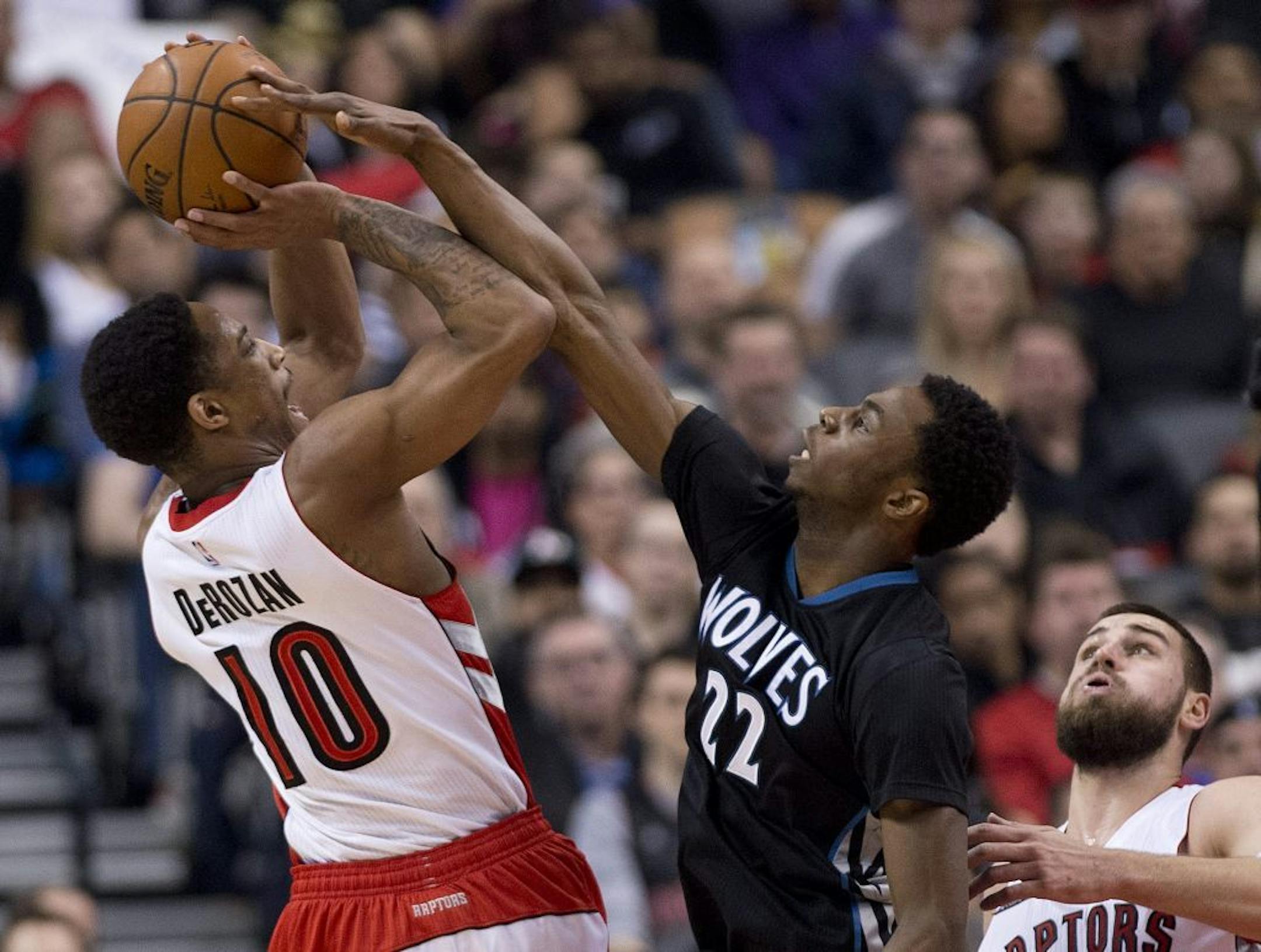 Toronto Raptors' DeMar DeRozan (10) gets fouled by Minnesota Timberwolves' Andrew Wiggins (22) during the first half of an NBA basketball game, Wednesday, March 18, 2015 in Toronto.