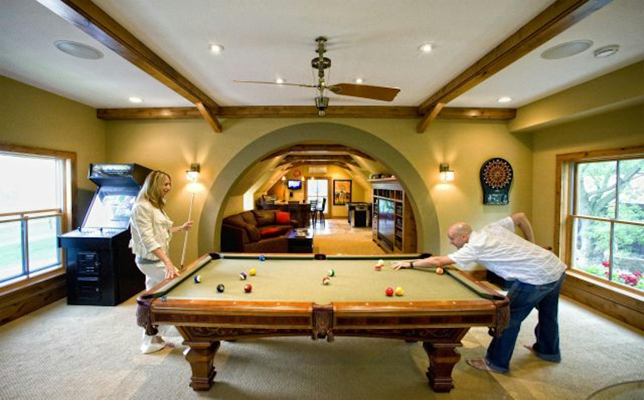Jeff Murphy and his wife Jill hit some pool balls in the upper level of the garage.
