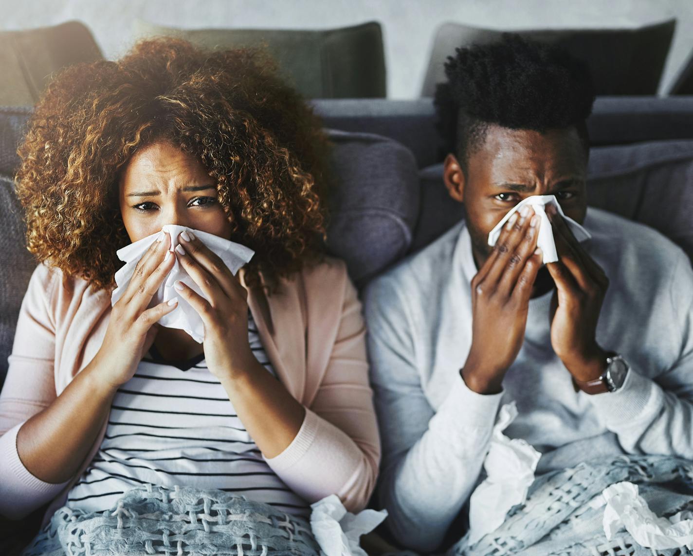 Portrait of a young couple suffering with flu at home