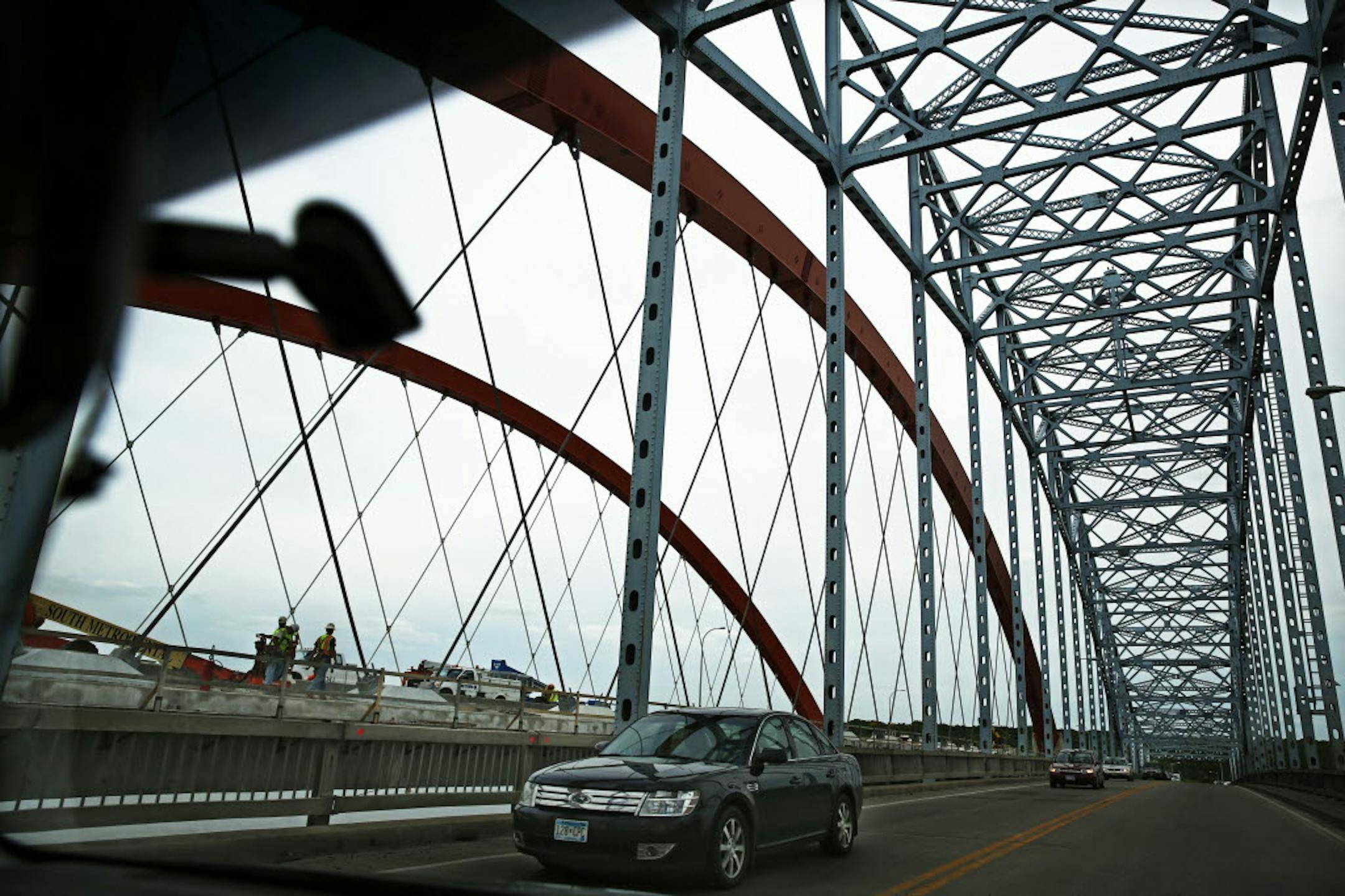 After two years of construction, Hastings' "Big Blue" bridge, above, will make way for the new $120 million span across the Mississippi River, opening with one lane in each direction on Tuesday. The new Hwy. 61 bridge is being built right next to the old one.