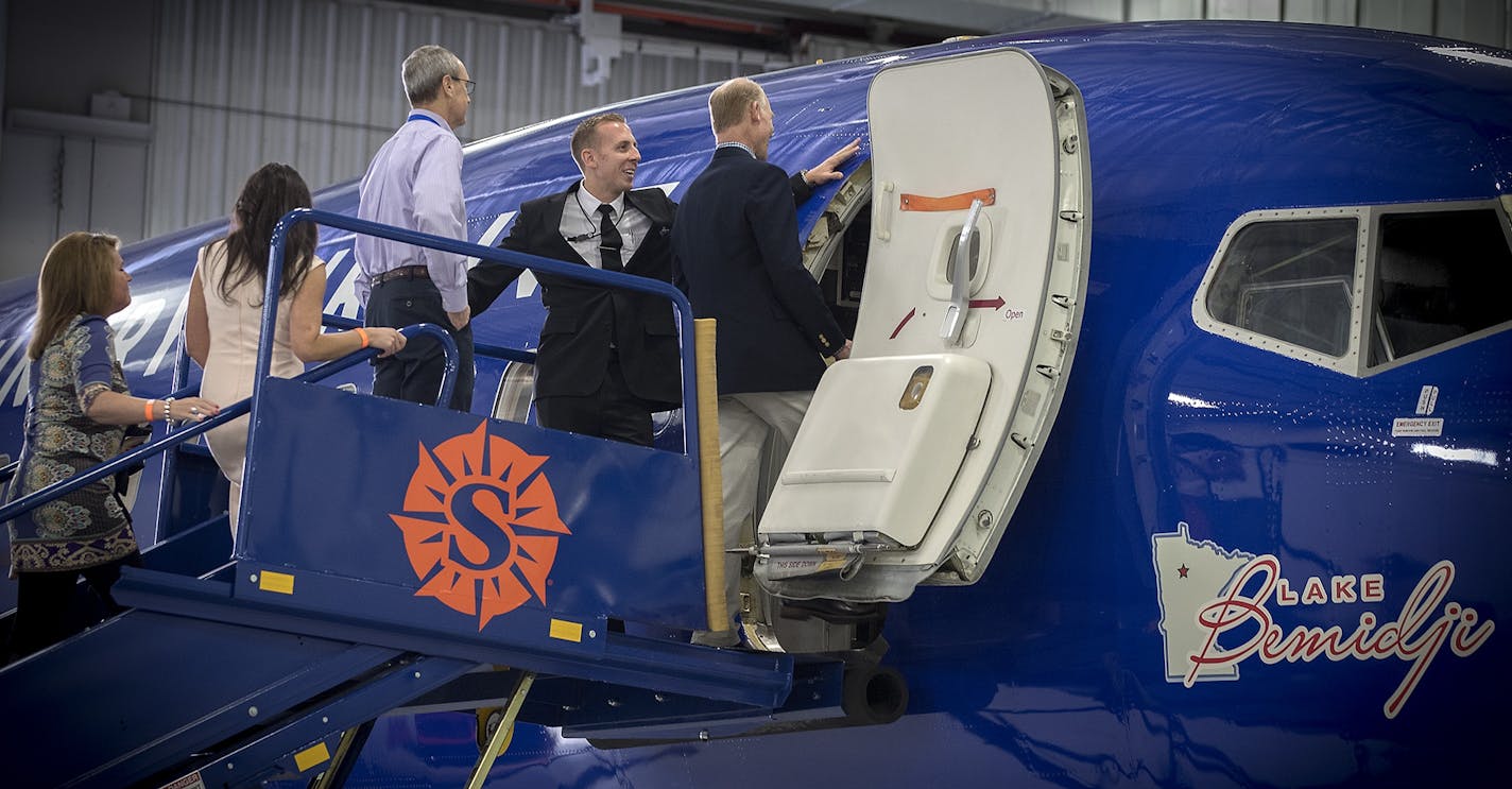 Guest got a first-hand look at Sun Country Airlines's dedication to Minnesota Lakes during a ceremony, Tuesday, April 11, 2017 in Bloomington, MN. The airline is naming each of its airplanes after a different lake in Minnesota. The art, by local artist Mark Herman, was revealed on a finished plane in the Sun Country Hangar.