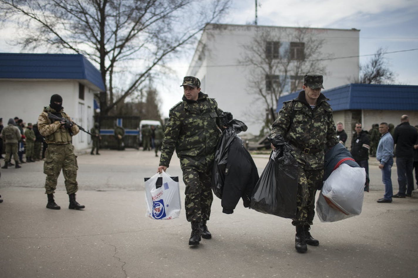 Ukrainian soldiers leave the country's navy headquarters after local militiamen backed by Russian forces seized the base in Sevastopol, Crimea, March 19, 2014.