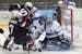 Goalkeeper Noora Raty of Finland reaches for the puck as Anna Kilponen of Finland (5) keeps Meghan Duggan of the Untied States (10) and Jocelyne Lamou