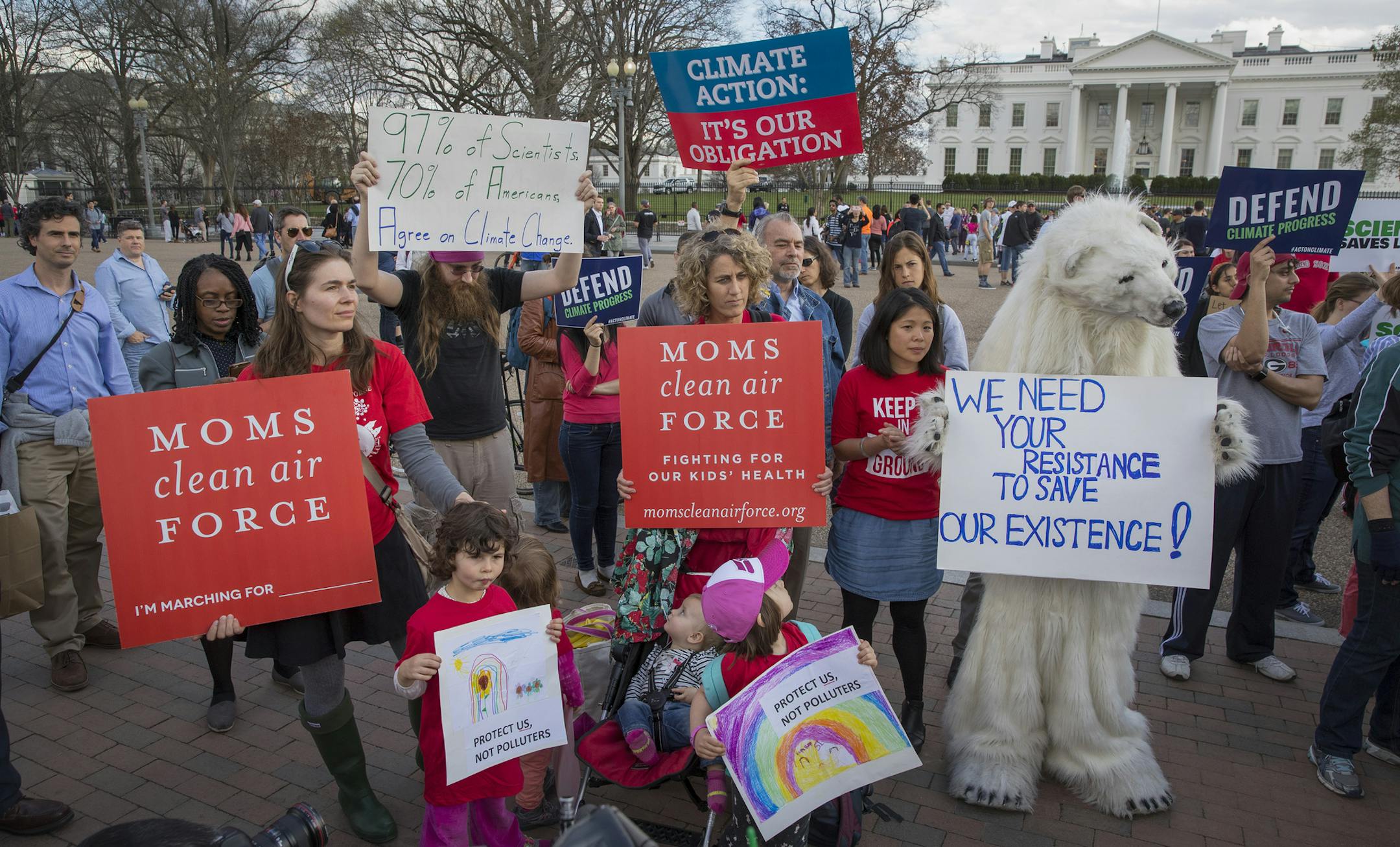 FILE-- Protesters, one in a polar bear costume, demonstrate against President Donald Trump's executive order outside the White House in Washington, March 28, 2017. The social cost of carbon, the estimated monetary damages caused by the release of an additional ton of carbon dioxide into the atmosphere, is the linchpin for how the federal government values climate damages. How we calculate that cost can protect us against disruptive climate change. (Stephen Crowley/The New York Times)