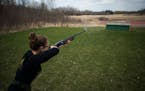Smoke rises from the barrel of the shotgun of Kerri Mueller, a junior at Wayzata and member of the varsity team, during practice on Thursday afternoon