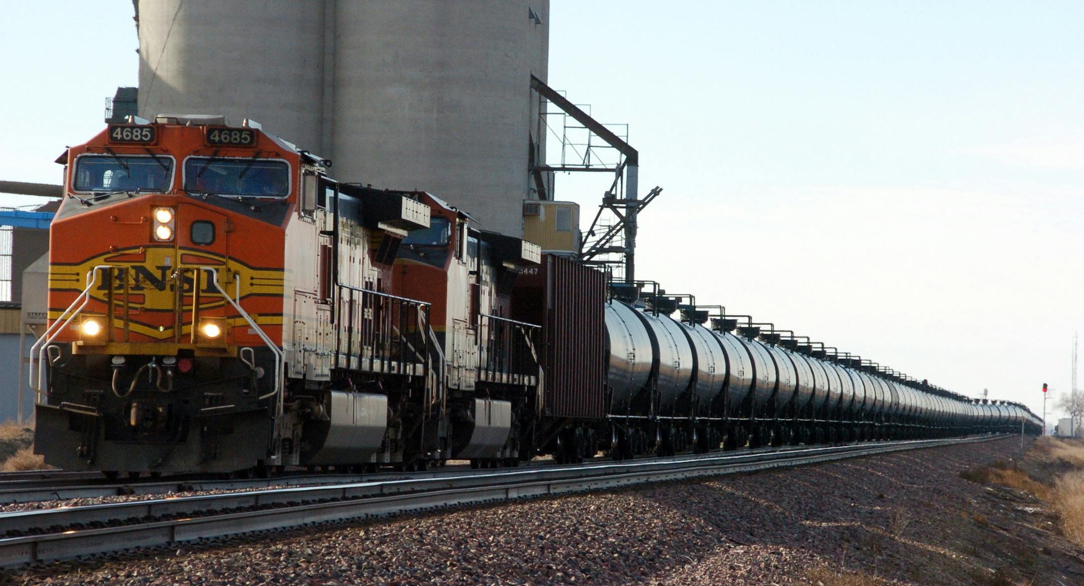 FILE - This Nov. 6, 2013, file photo, shows a BNSF Railway train hauling crude oil near Wolf Point, Mont. BNSF Railway Co. said Thursday, Feb. 20, 2014, it intends to buy a fleet of 5,000 strengthened tank cars to haul oil and ethanol in a move that would set a higher safety standard for a fleet that's seen multiple major accidents.(AP Photo/Matthew Brown, File)