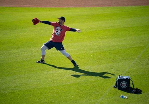 Danny Coulombe played catch early in Twins camp in Fort Myers, Fla.