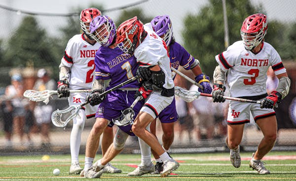 Cretin-Derham Hall's Luke Chorlton (1) put a hit on Lakeville North's Blake Piscitiello near the Raiders' goal late in the game. North won the state t