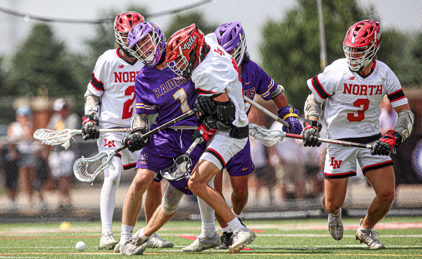 Cretin-Derham Hall's Luke Chorlton (1) put a hit on Lakeville North's Blake Piscitiello near the Raiders' goal late in the game. North won the state tournament quarterfinal 7-5 at Stillwater High School on Tuesday, June 13, 2023. Photo by Mark Hvidsten